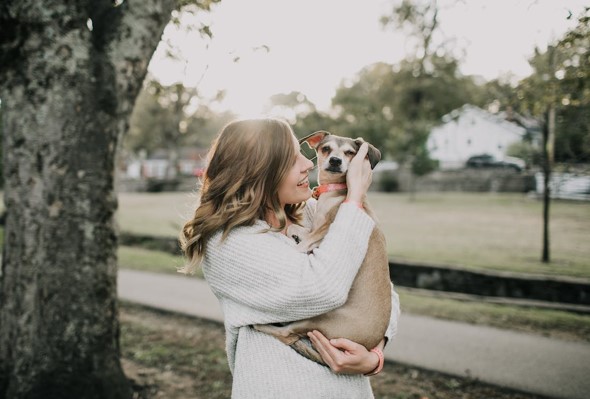 dog in owners arms